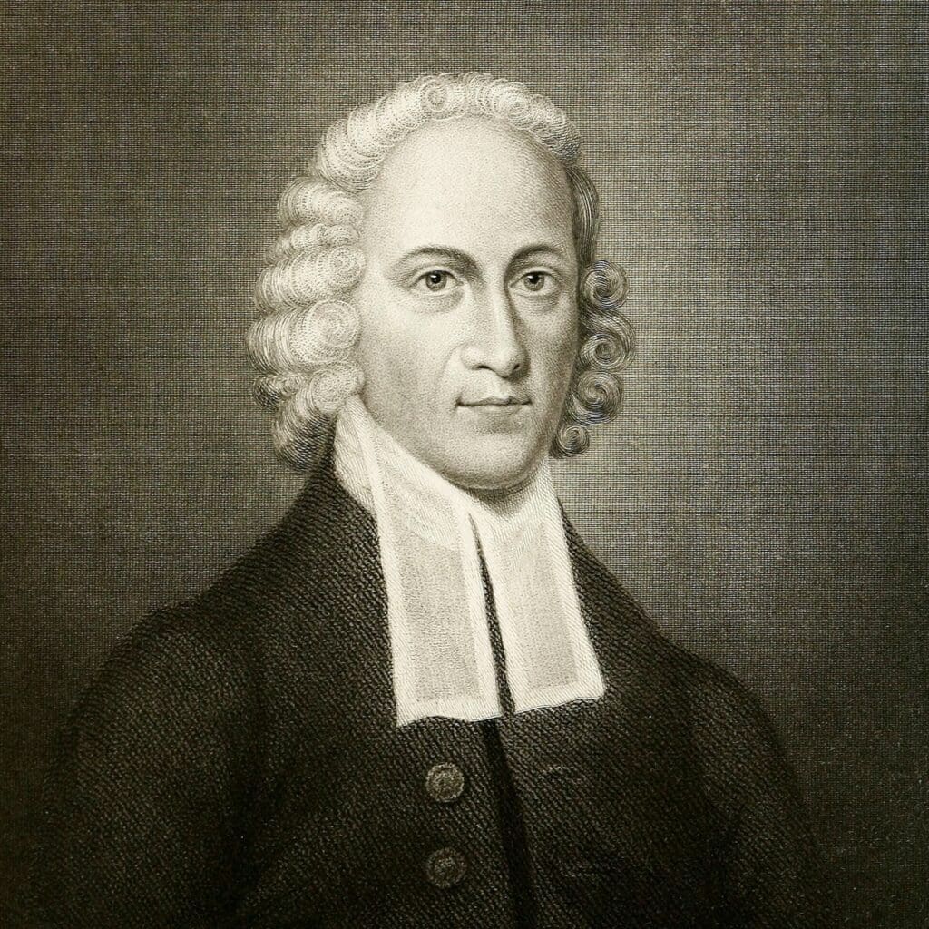 A black-and-white portrait illustration of a man with curly hair wearing a dark coat and a white clerical collar, facing forward with a neutral expression.