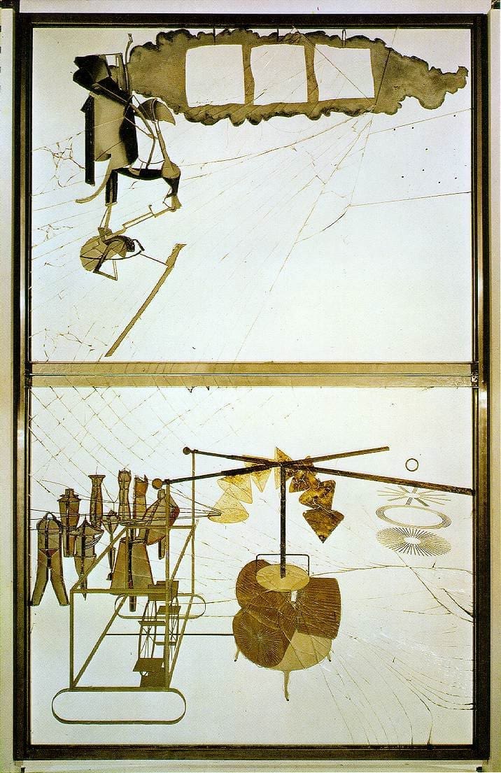 A large glass artwork with abstract mechanical shapes and cracks, featuring gold, brown, and gray elements. The composition is divided horizontally, with forms resembling machines and geometric objects.