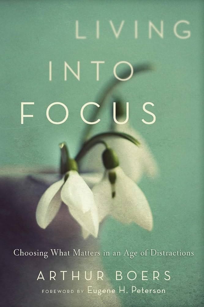 41btm4c6tuL._SX331_BO1,204,203,200_ Book cover for Living Into Focus by Arthur Boers, featuring two white snowdrop flowers against a soft teal background. Subtitle reads: Choosing What Matters in an Age of Distractions.
